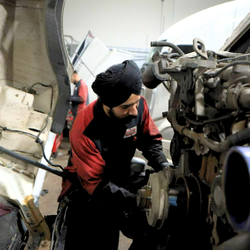 truck brake repair Winnipeg mechanic inspecting brake drum